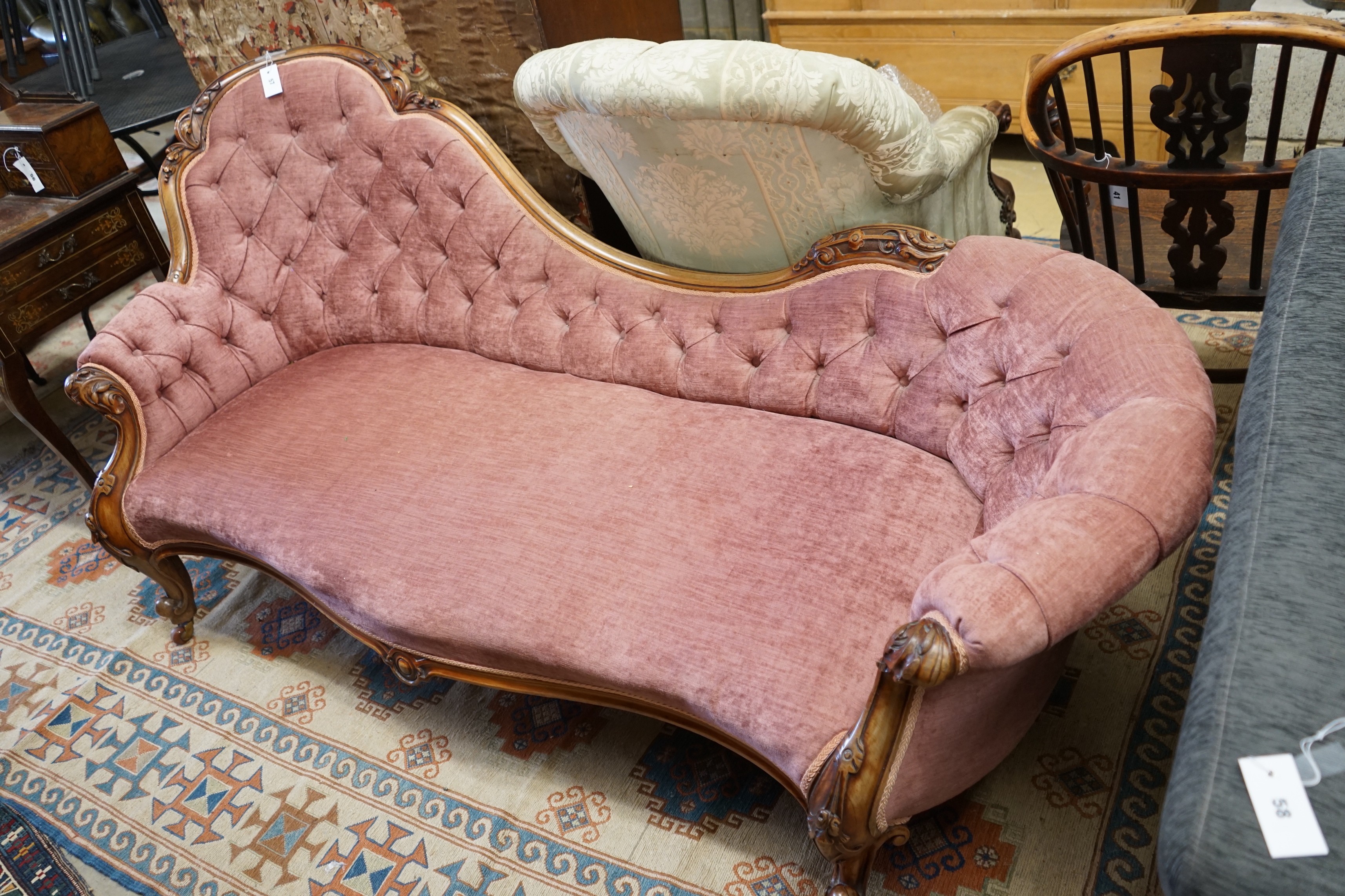 A Victorian faded rosewood chaise longue upholstered in buttoned pink dralon, length 190cm, width 80cm, height 88cm